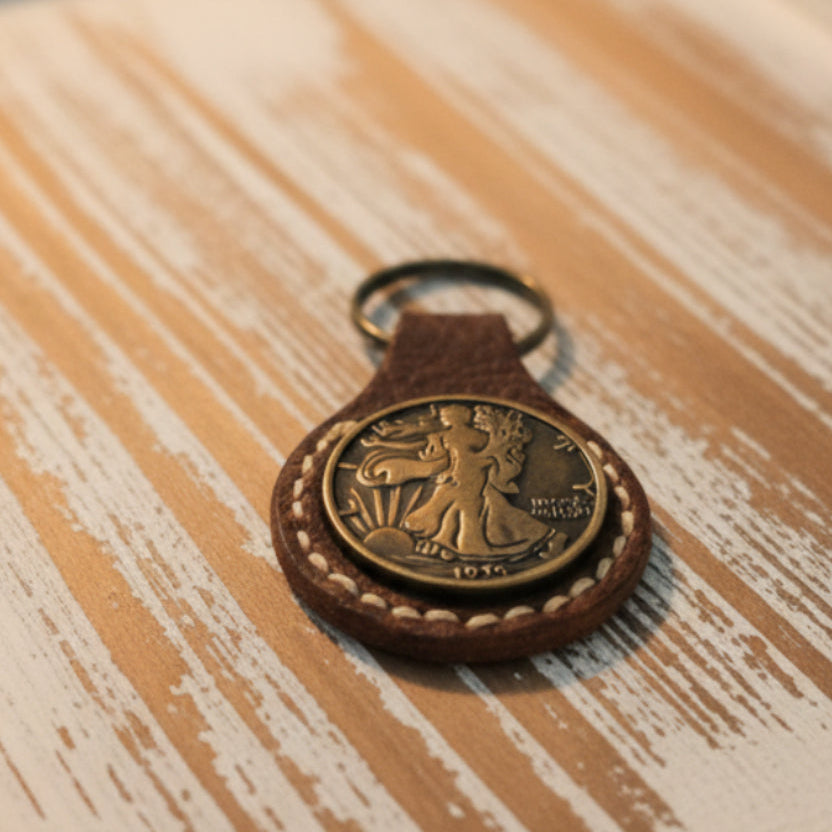 Keychain with a decorative emblem on a textured fabric background
