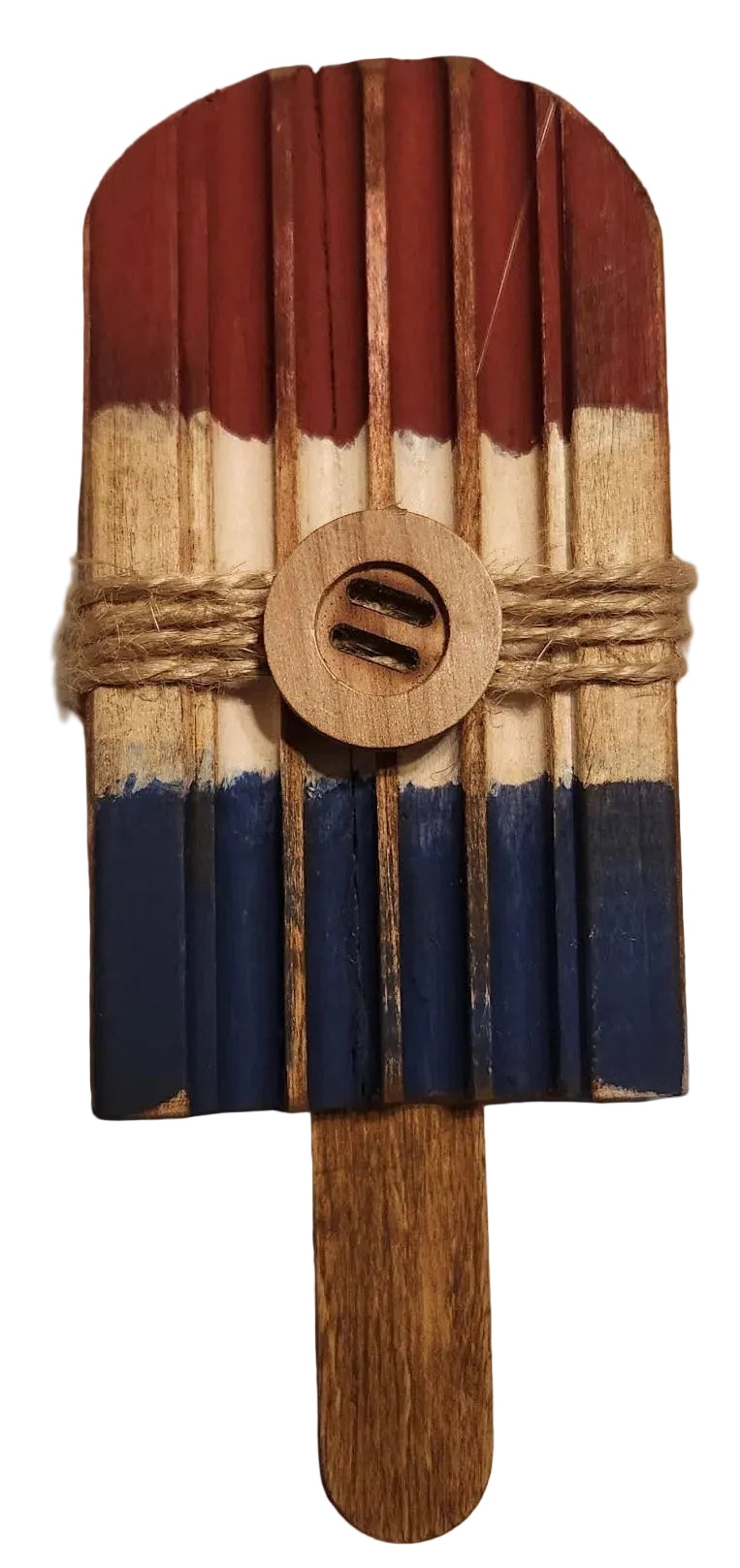 Decorative item resembling a popsicle with red, white, and blue stripes on a beige background