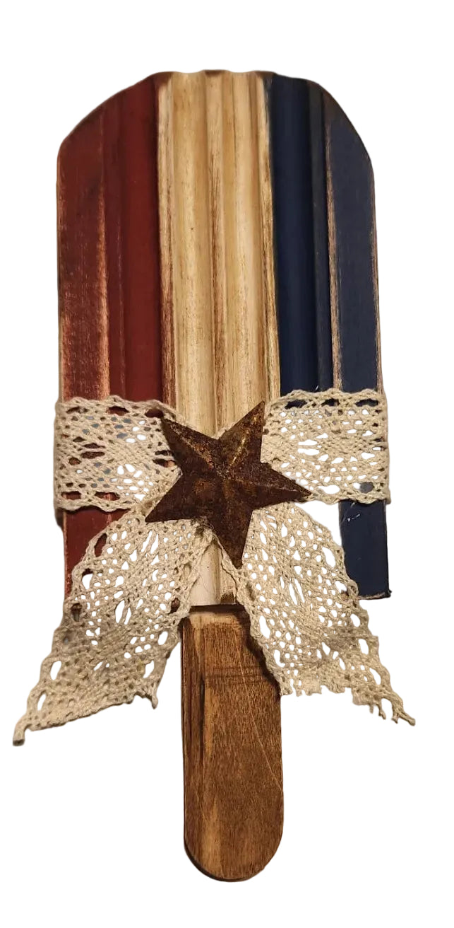 Decorative paddle with star and lace on a wooden surface