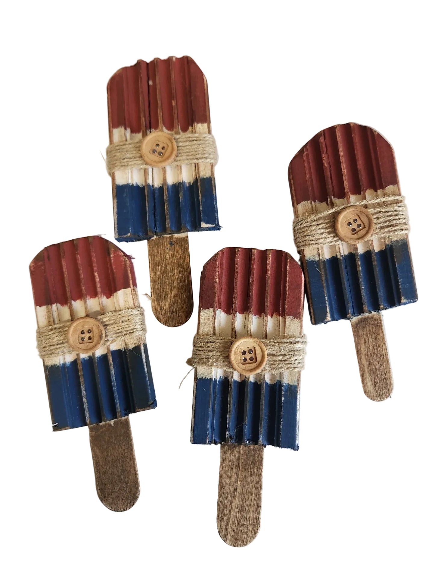Four decorative popsicles with a striped pattern on a light background