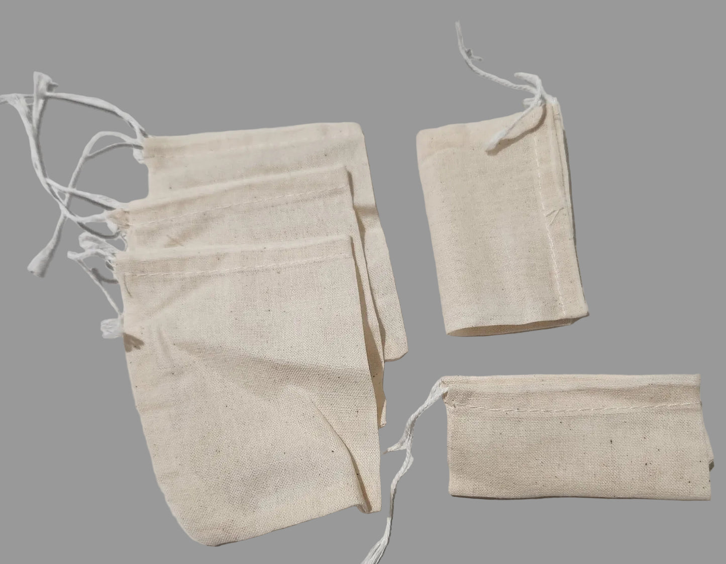 Set of beige fabric bags on a light gray background
