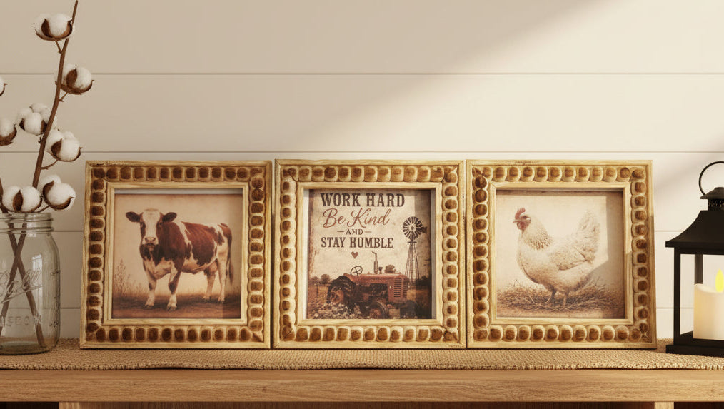 Three framed pictures of a cow, a chicken, and a motivational quote on a textured surface.